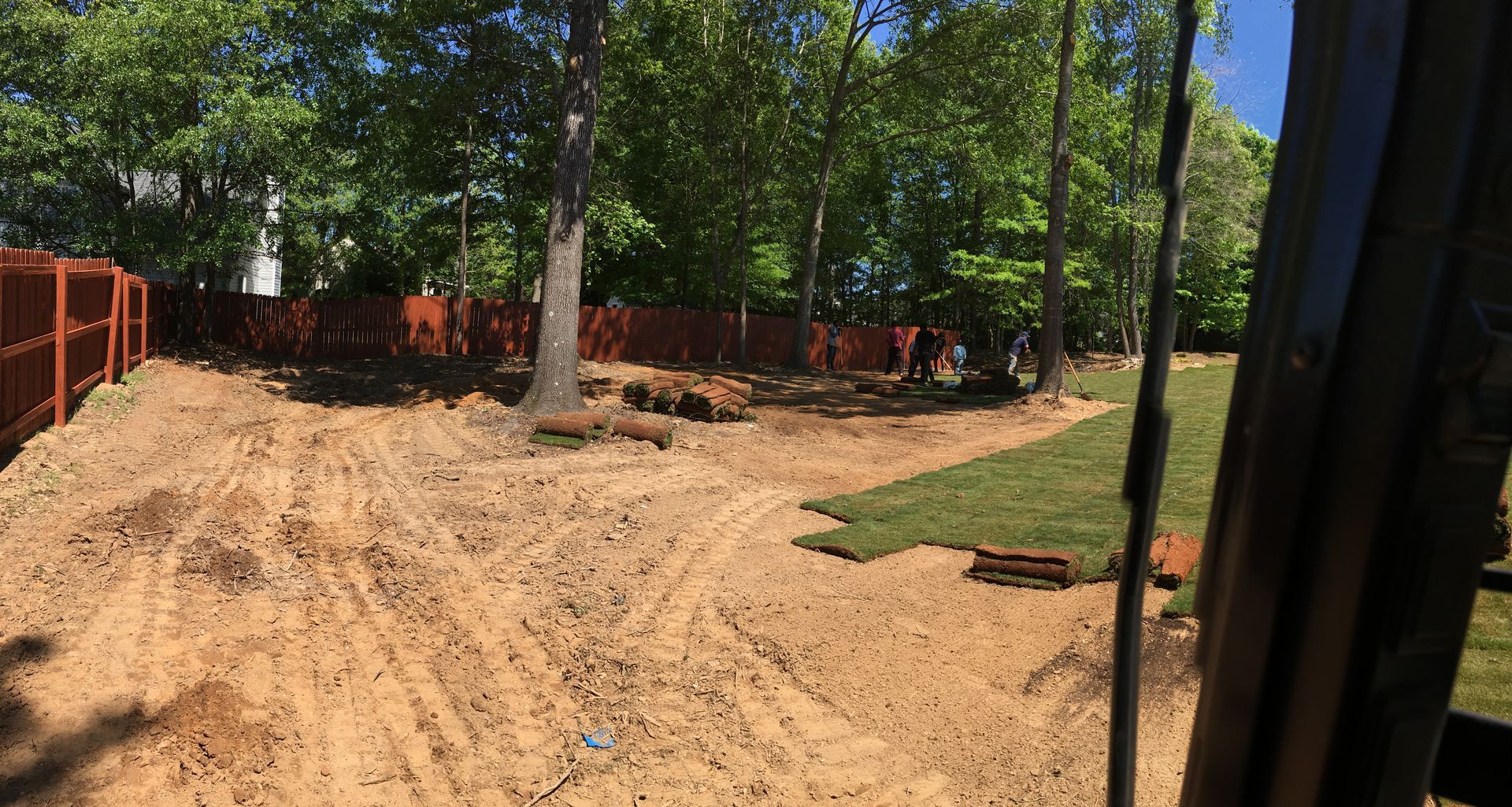 A yellow bulldozer is parked in a dirt field.