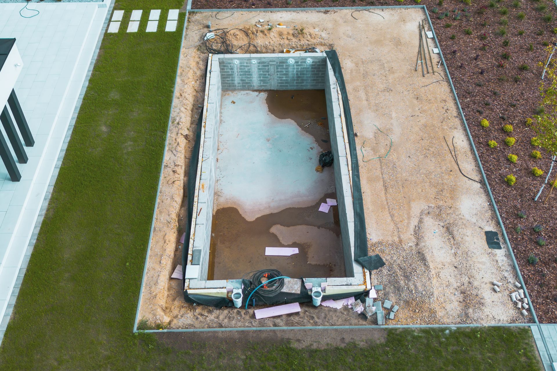 An aerial view of a swimming pool under construction.