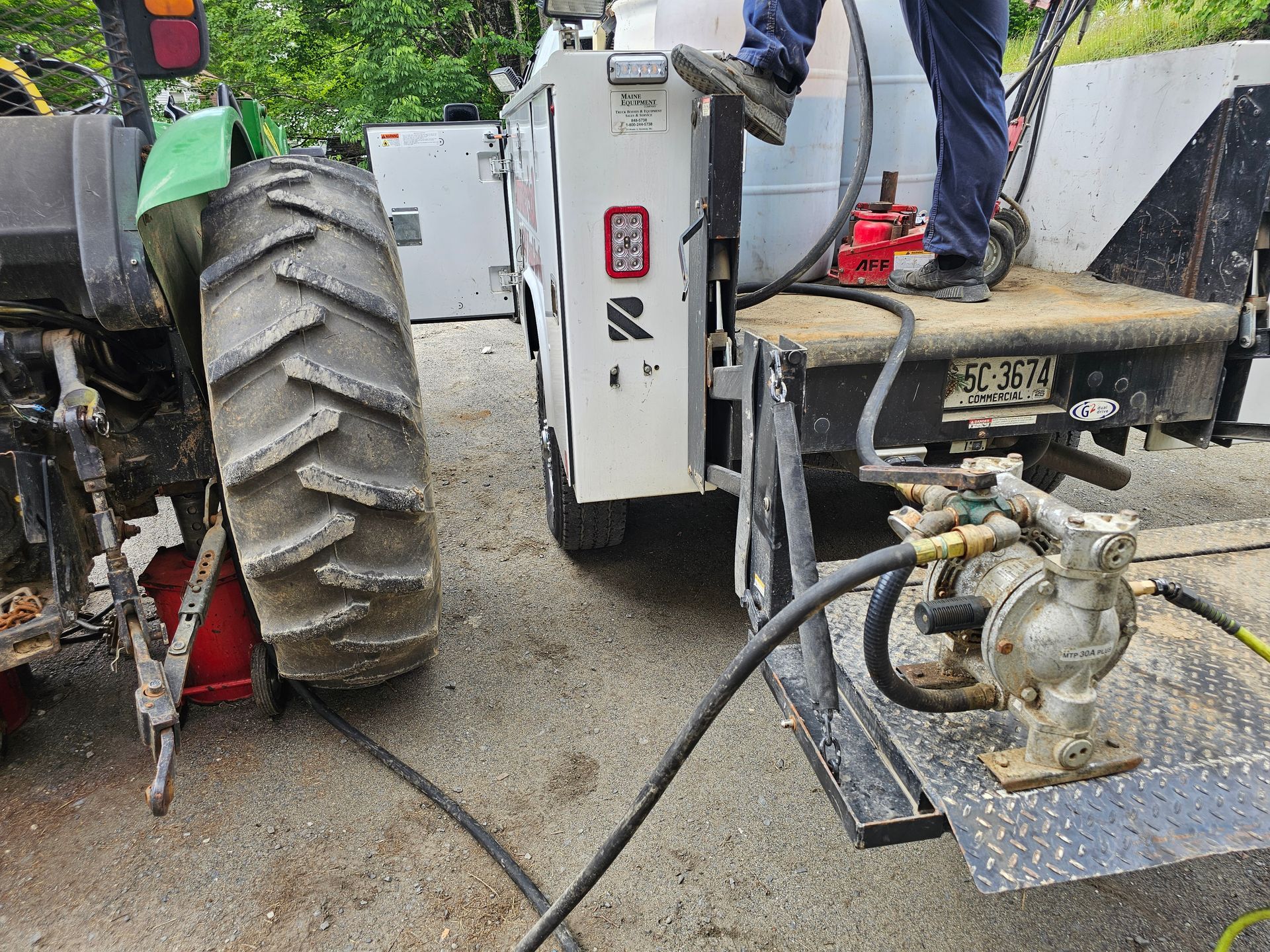 A man is pumping gas into a tractor.