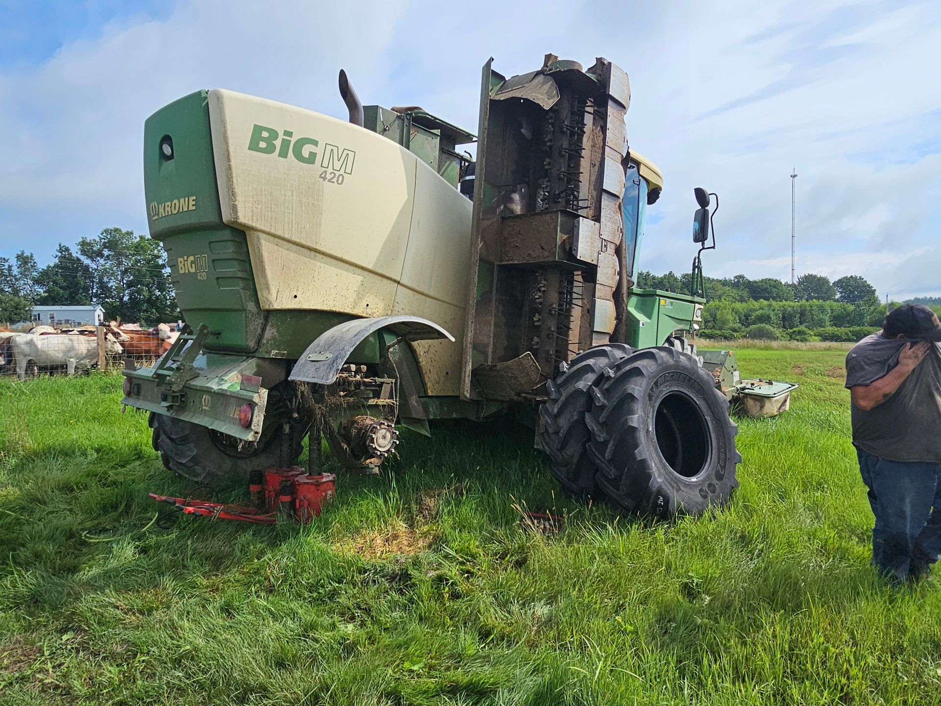 A tractor is sitting in the middle of a grassy field.
