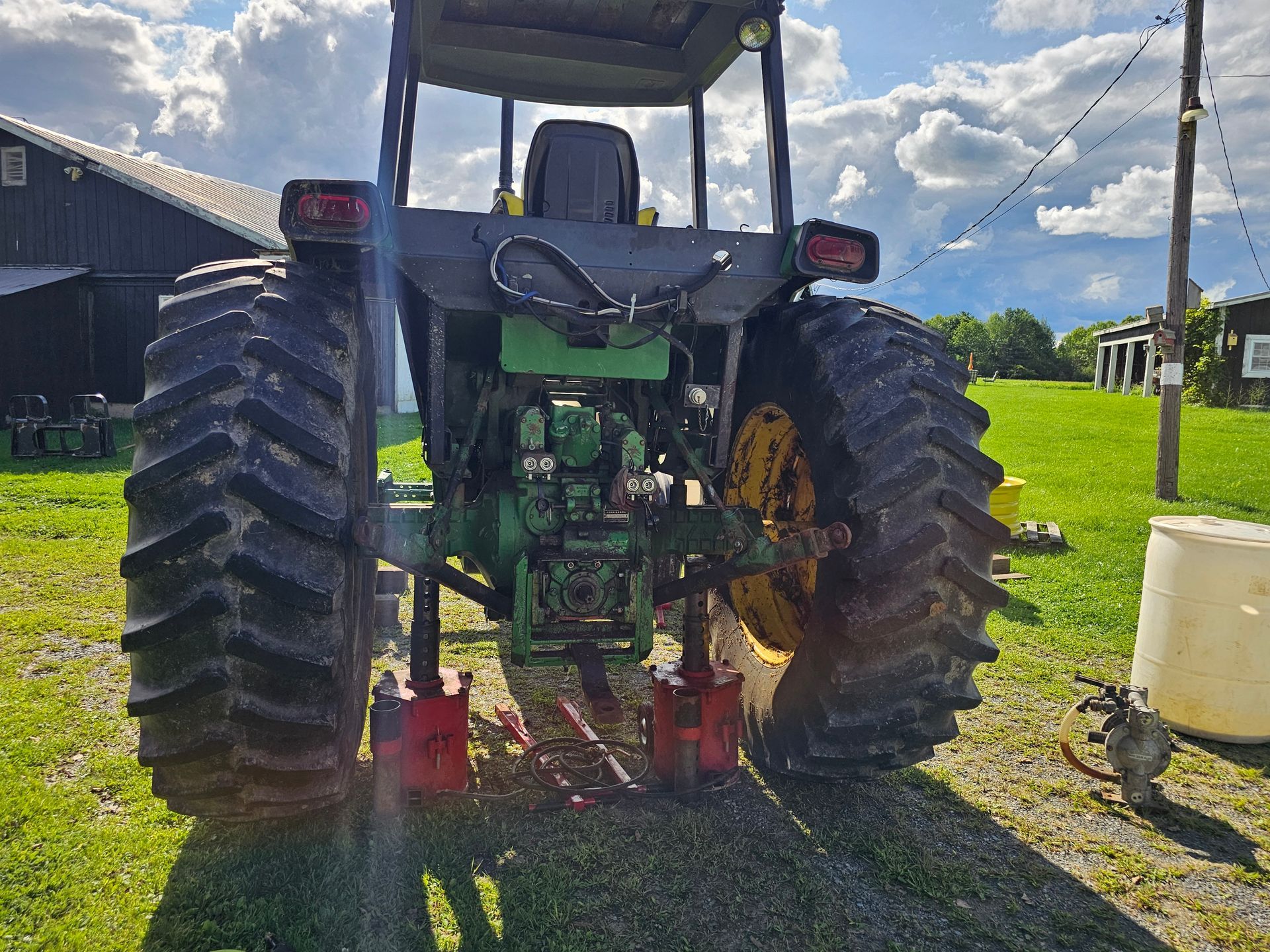 A green tractor is parked in a grassy field.