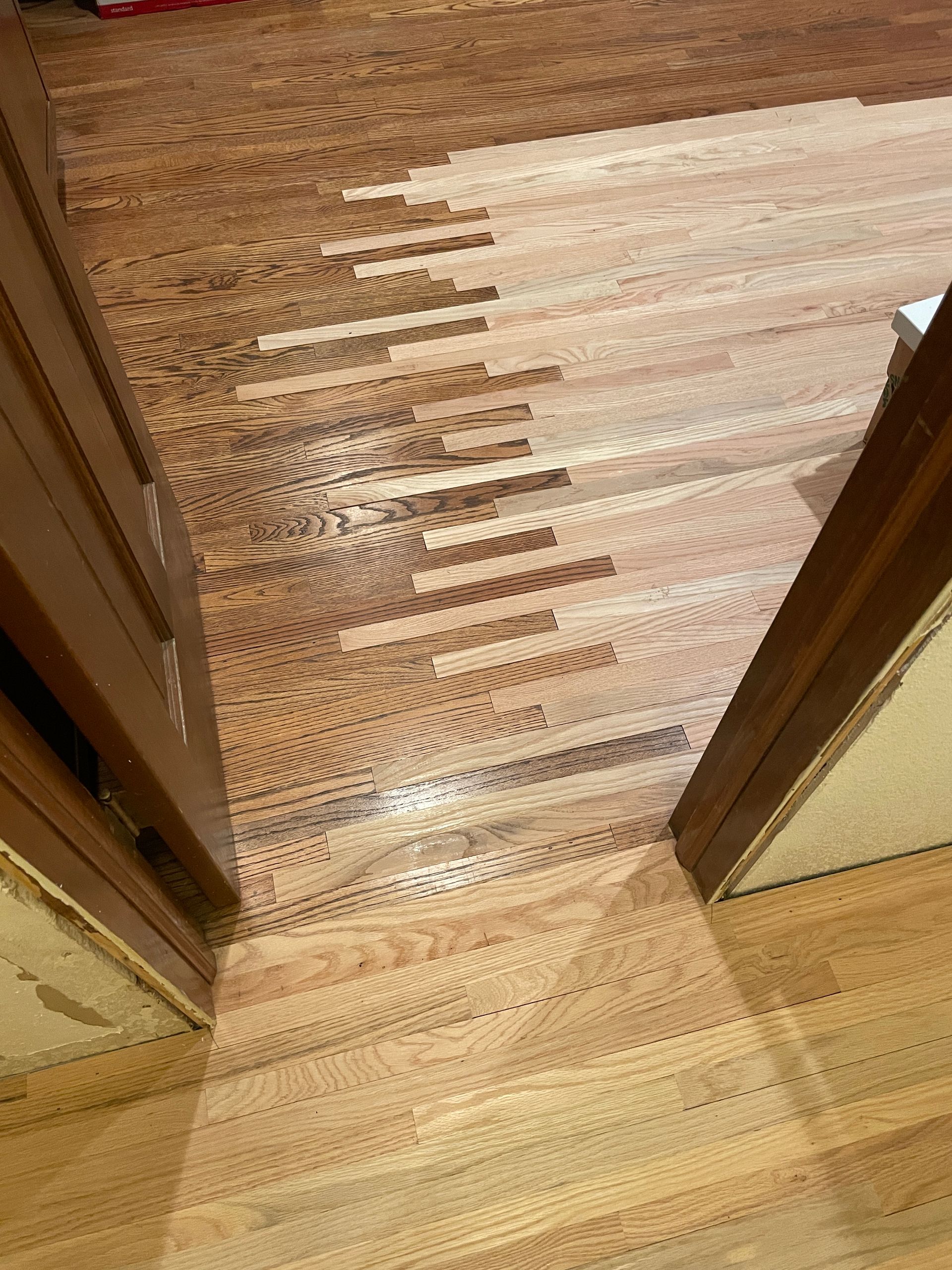 An empty closet with newly installed hardwood floors.