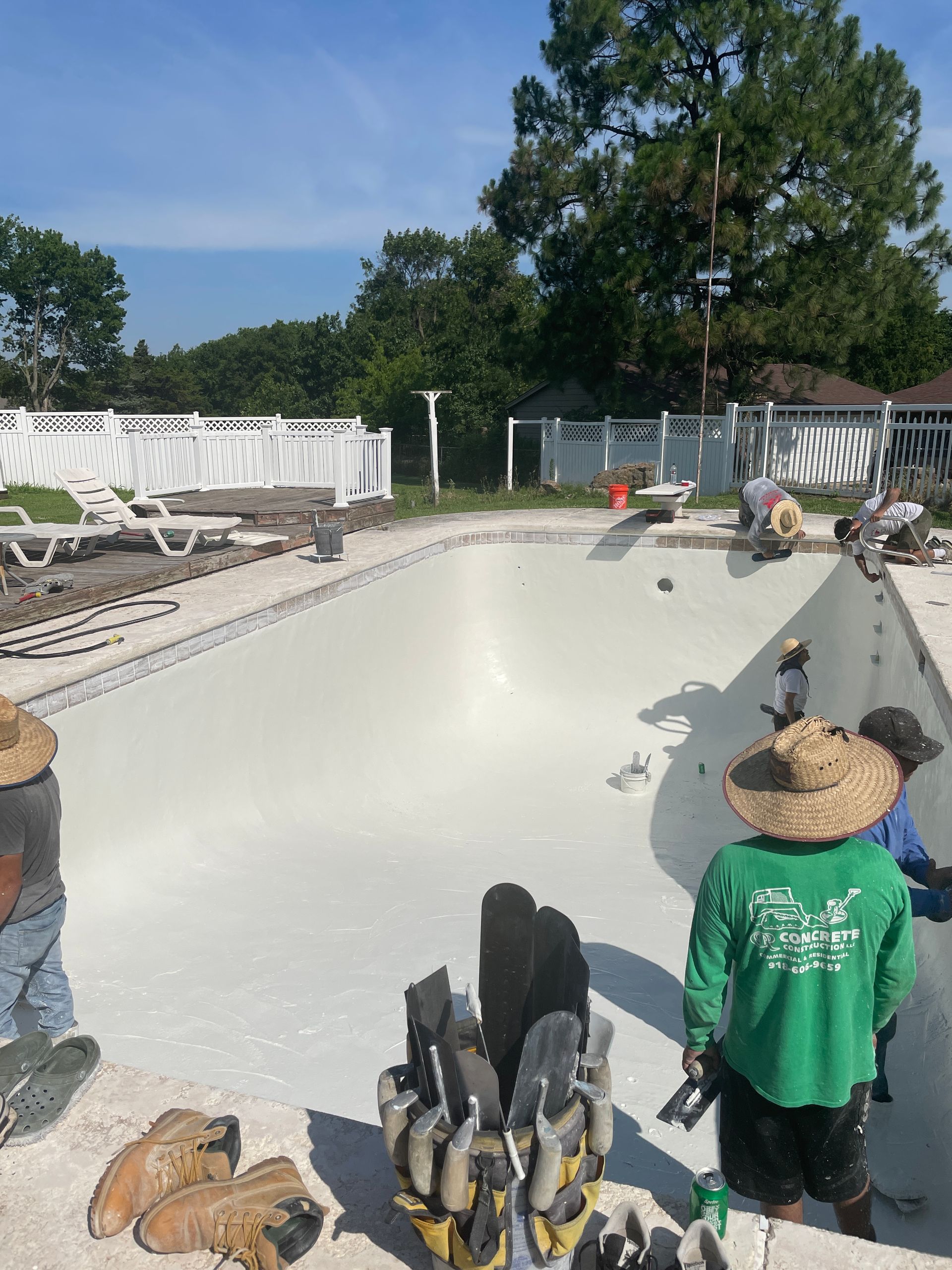 A group of people are working on a swimming pool.