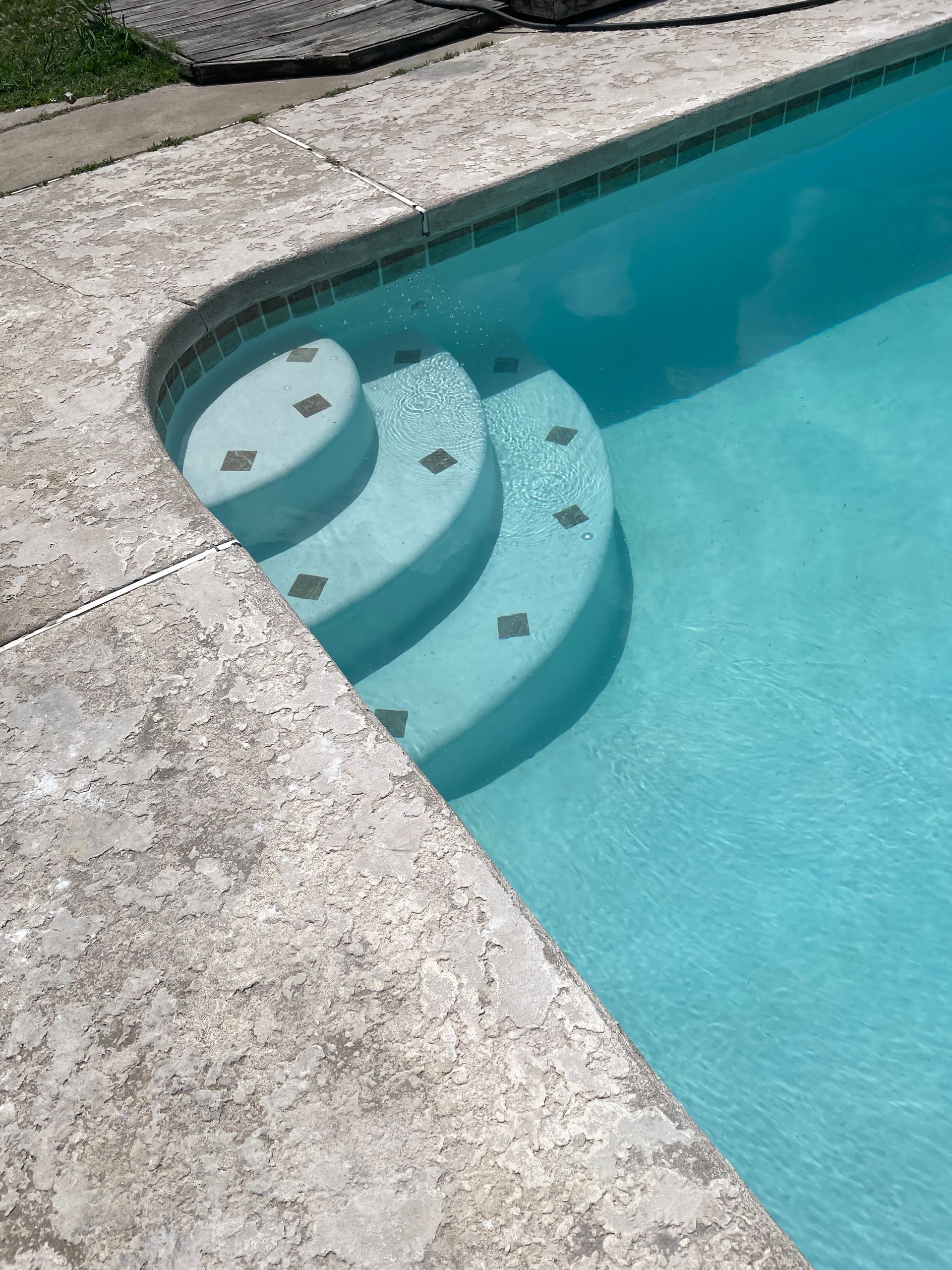 A swimming pool with stairs leading up to it