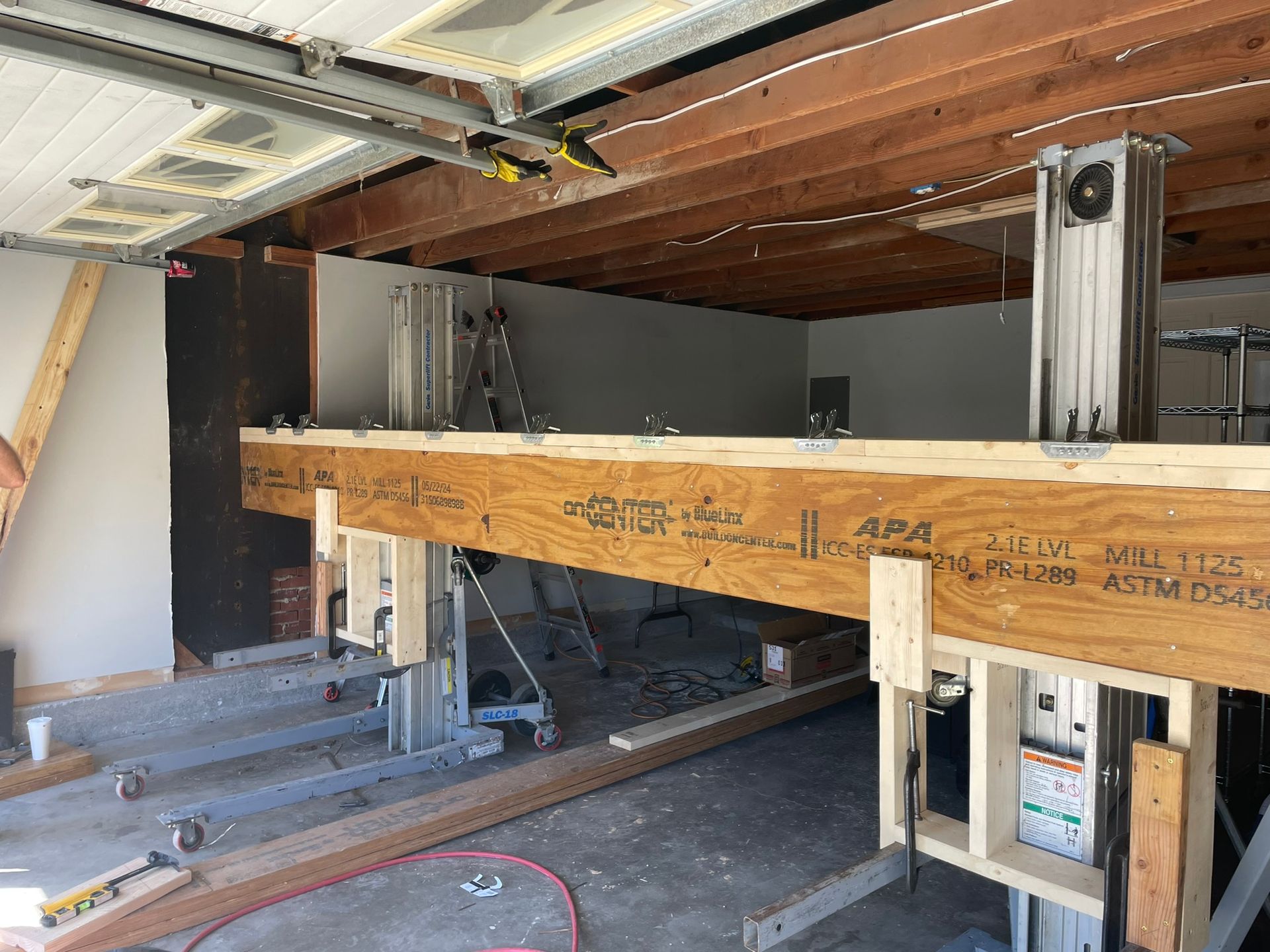 A garage under construction with a lot of wood and metal.