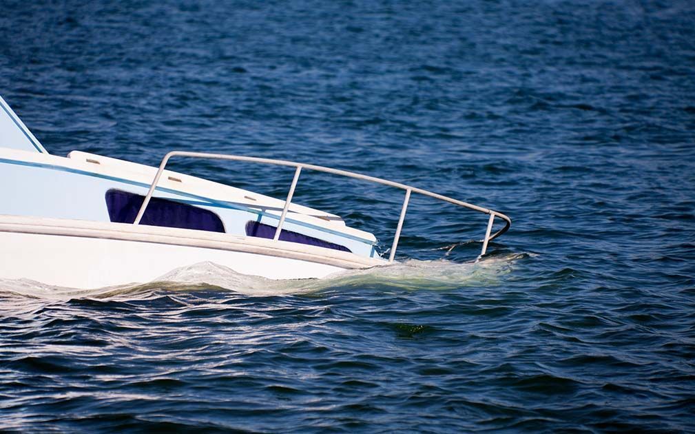 A white boat is floating on top of a body of water.