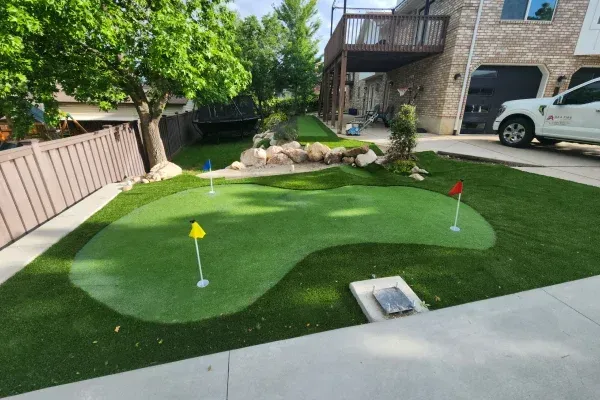 Artificial turf installation in Ogden UT creating low maintenance green lawns for residential and commercial spaces