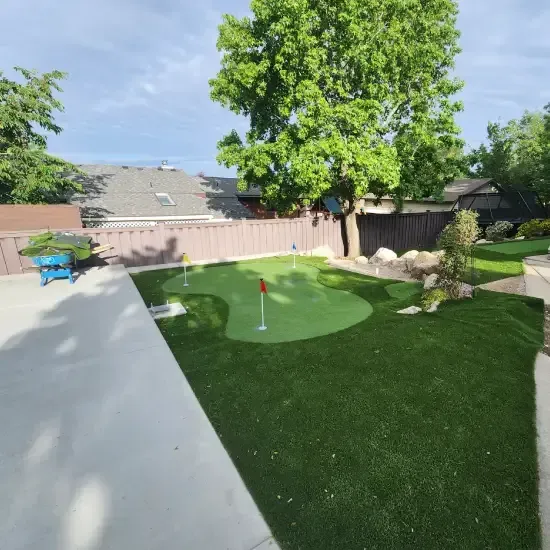 Synthetic grass landscape design in Ogden UT providing durable and water efficient lawn alternatives