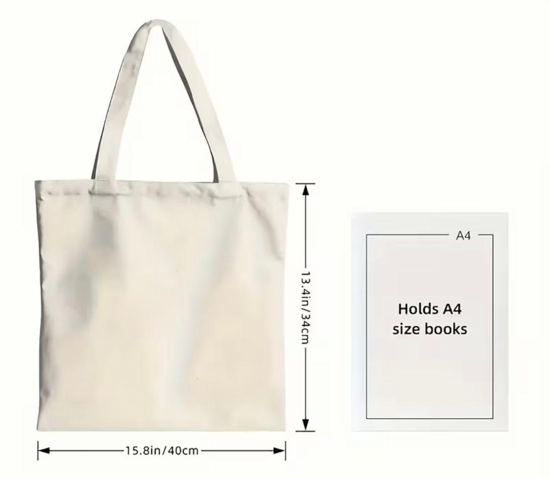 White tote bag on a wooden floor with a cartoon woman and text reading “OH, LOOK! NOBODY GIVES A SHIT.”