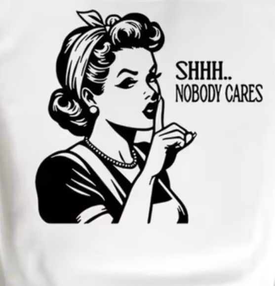 T-SHIRT Black-and-white cartoon woman holding a finger to her lips with text: “SHHH. NOBODY CARES”