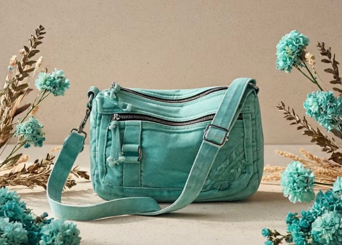 Four quilted crossbody bags in mint, blue denim, tan, and black on a light surface.