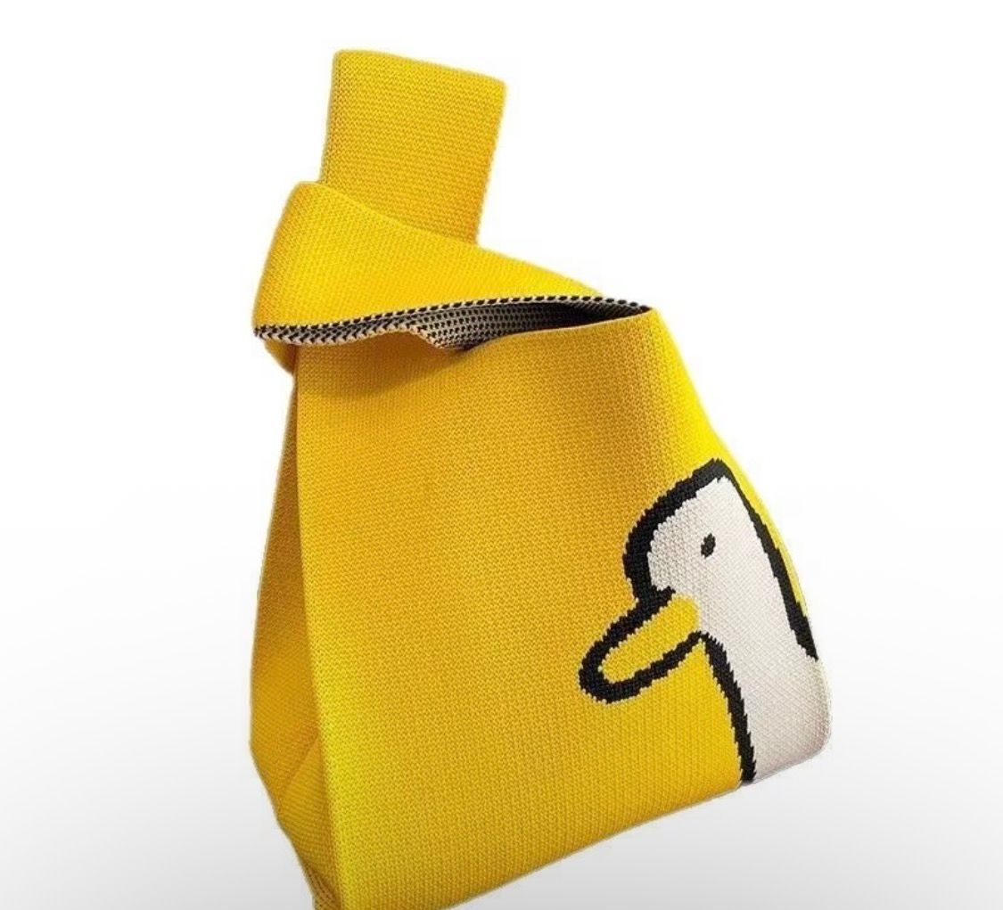 Yellow fabric bag with a small cartoon duck print and folded top