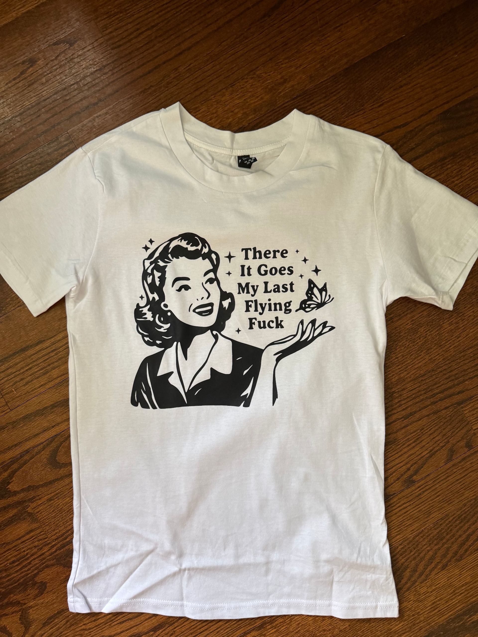 White T-shirt with black Marilyn Monroe graphic and text reading “There it goes. My last flying fuck.”