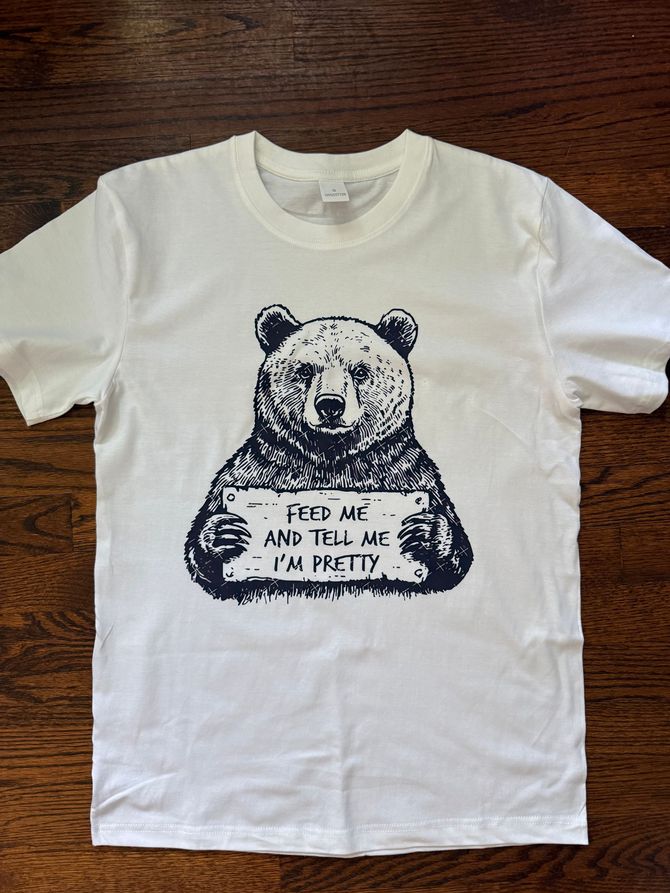 White T-shirt with a black panda graphic and the text “Find joy and the rest will follow.”