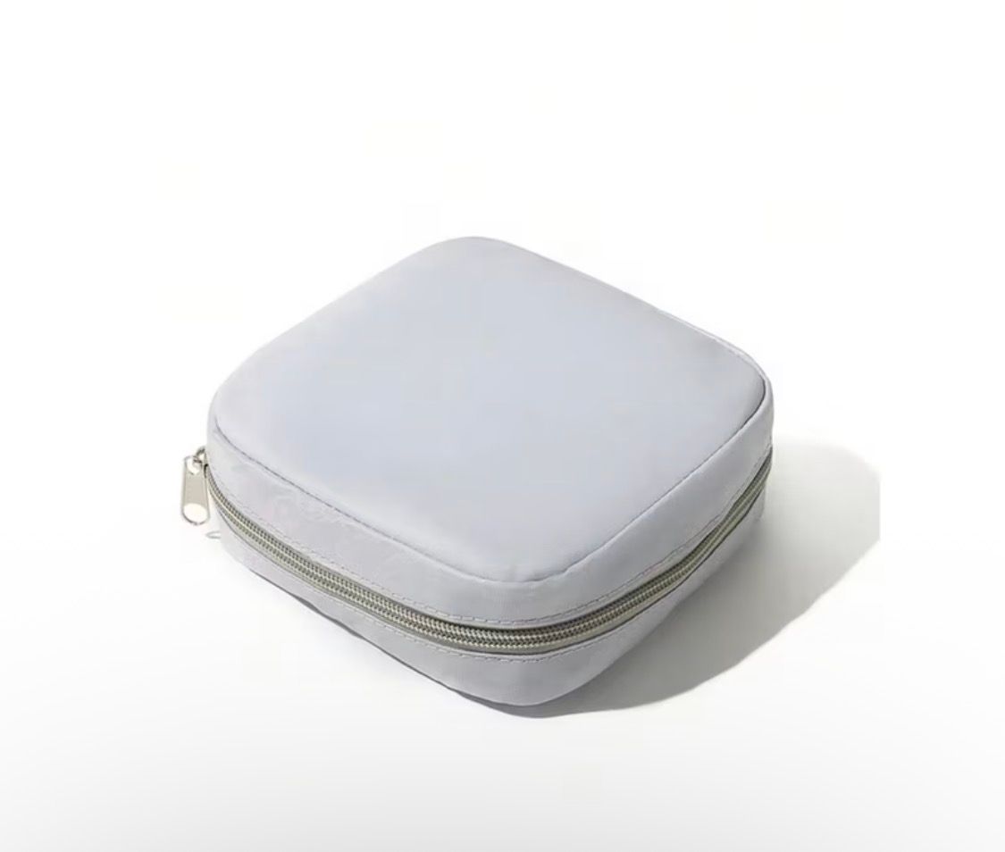 Pink zippered square pouch on a white background