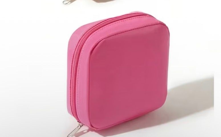 Pink zippered square pouch on a white background