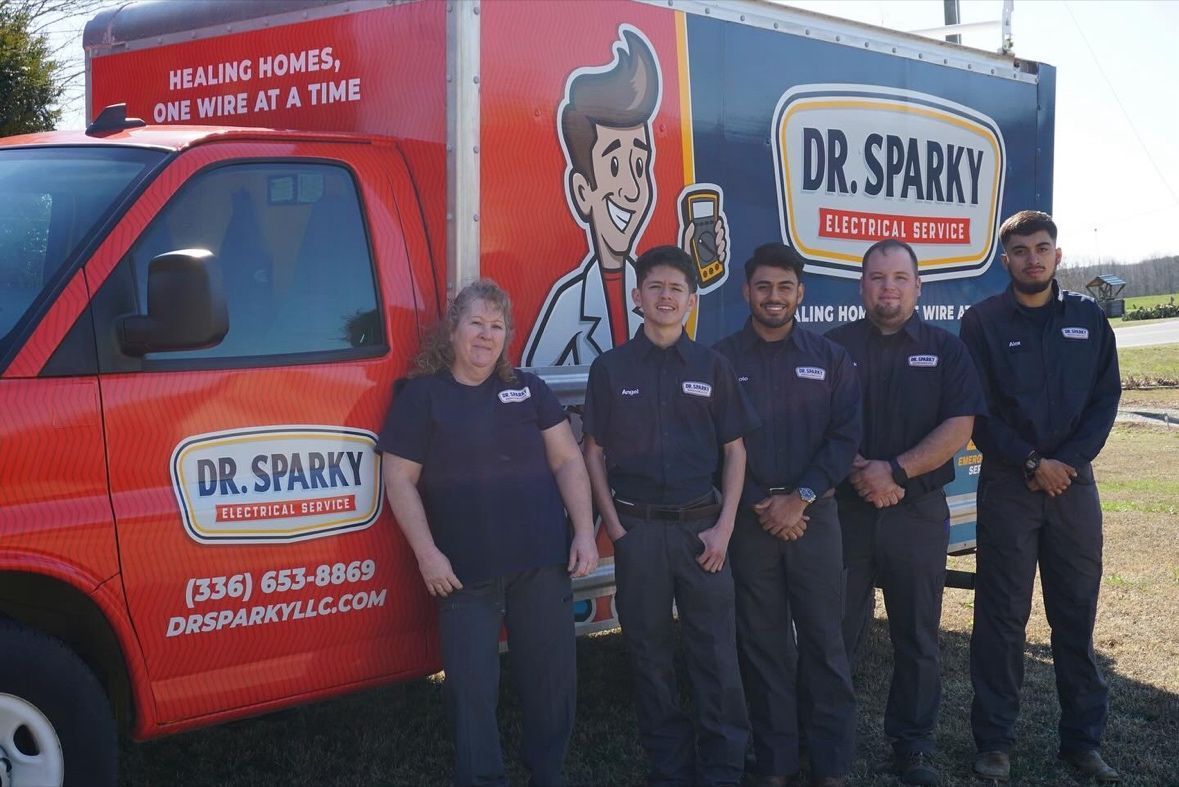 A man is working on an electrical box in a room