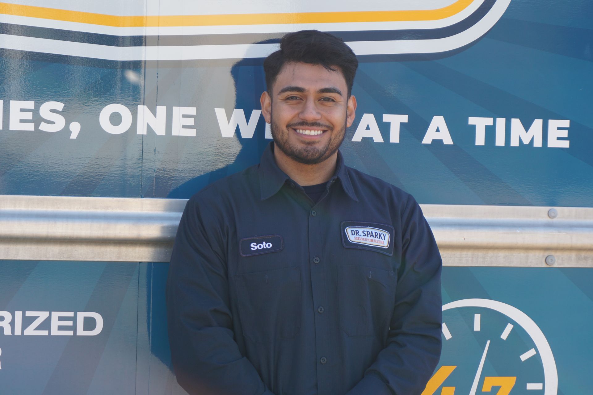 A large house with a large porch is lit up at night.