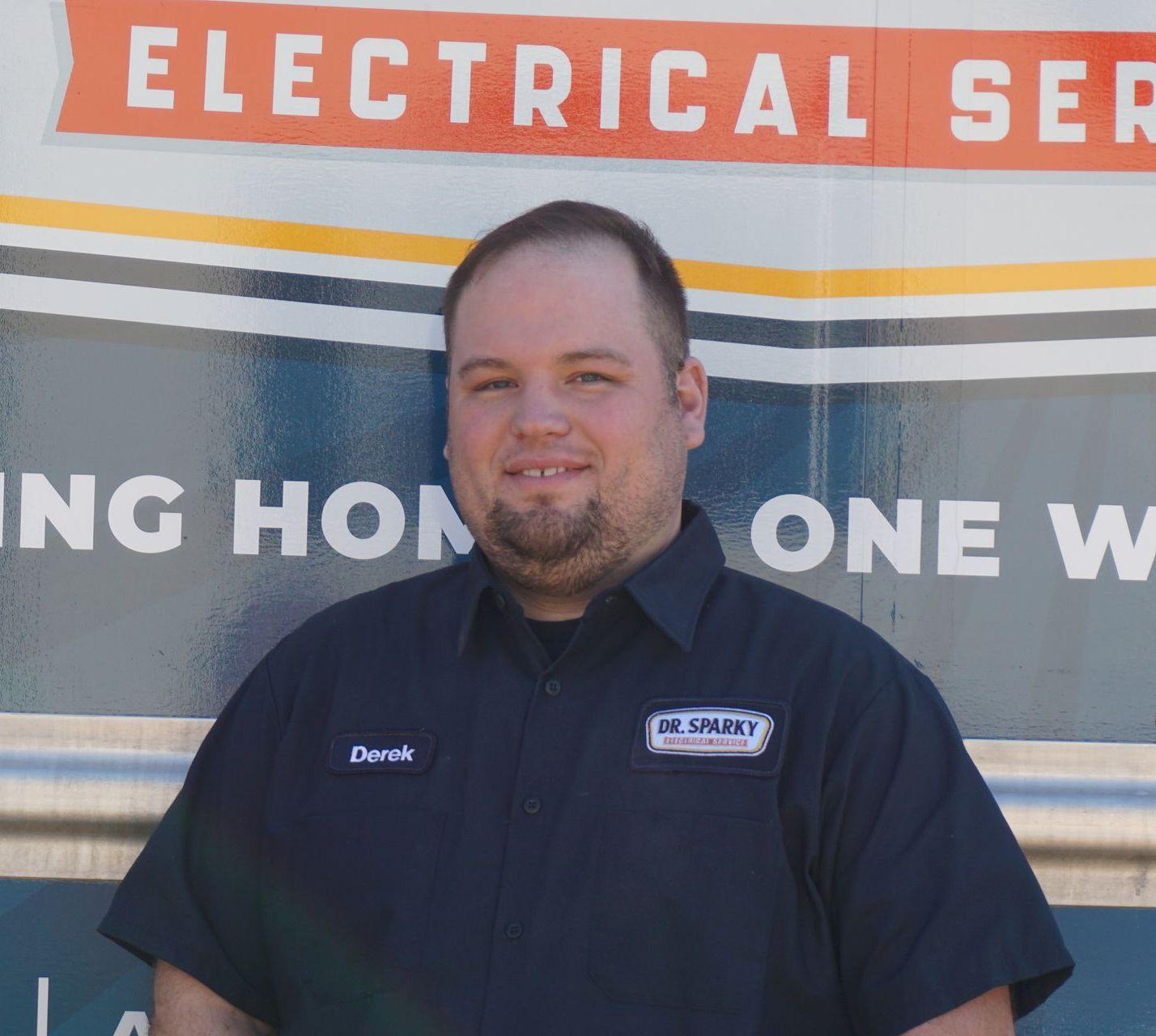 A row of houses with porches are lit up at night
