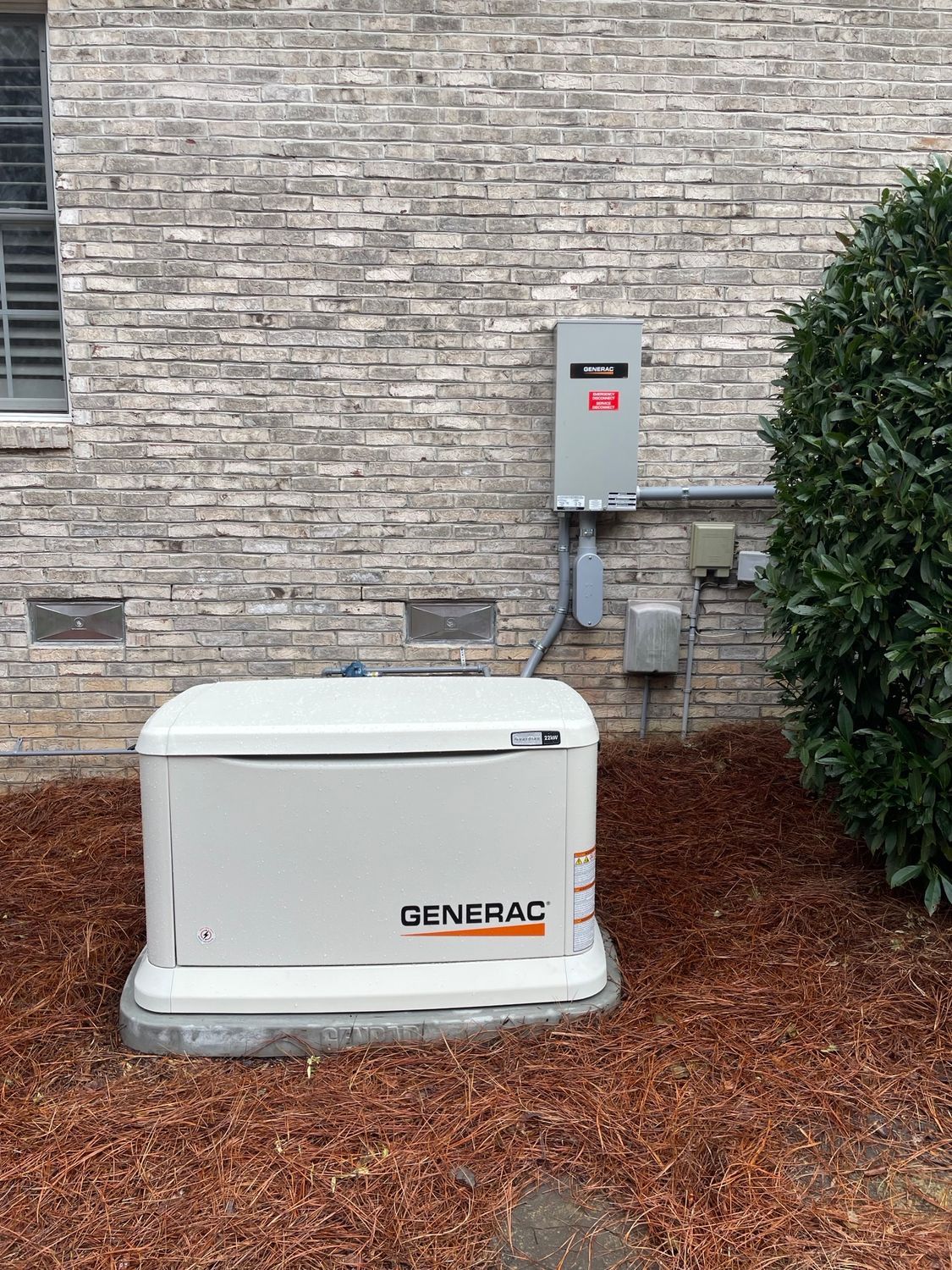 A man in a blue shirt is working on an generator.