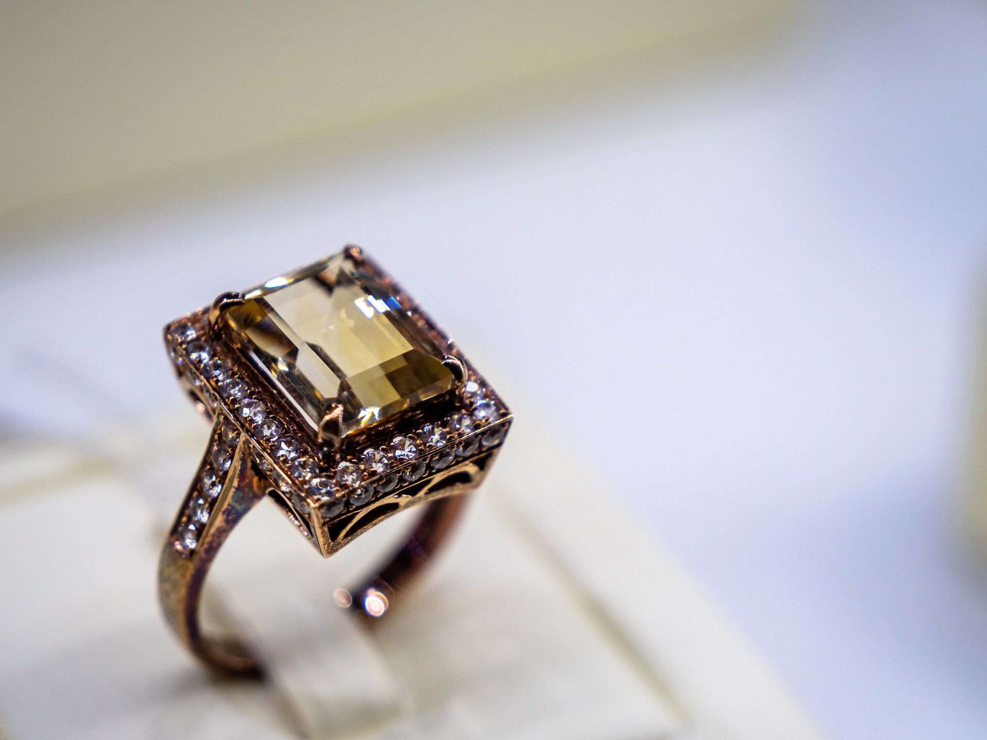 A gold ring with a square stone in the center