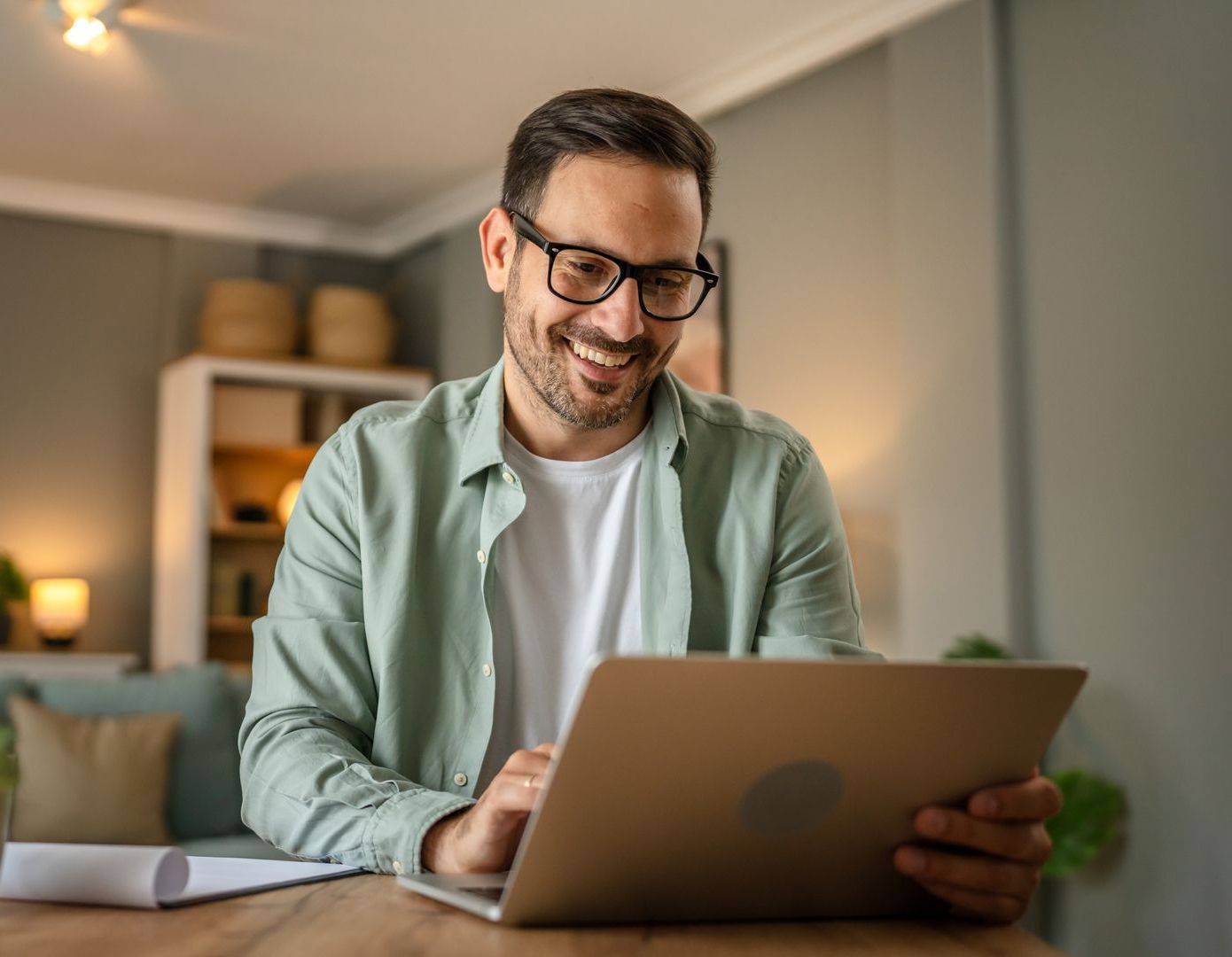 man using computer at home smiling