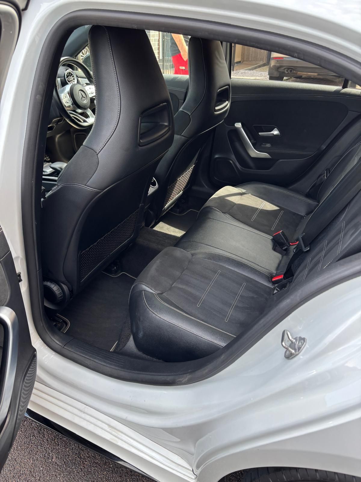 The interior of a range rover sport with white leather seats.