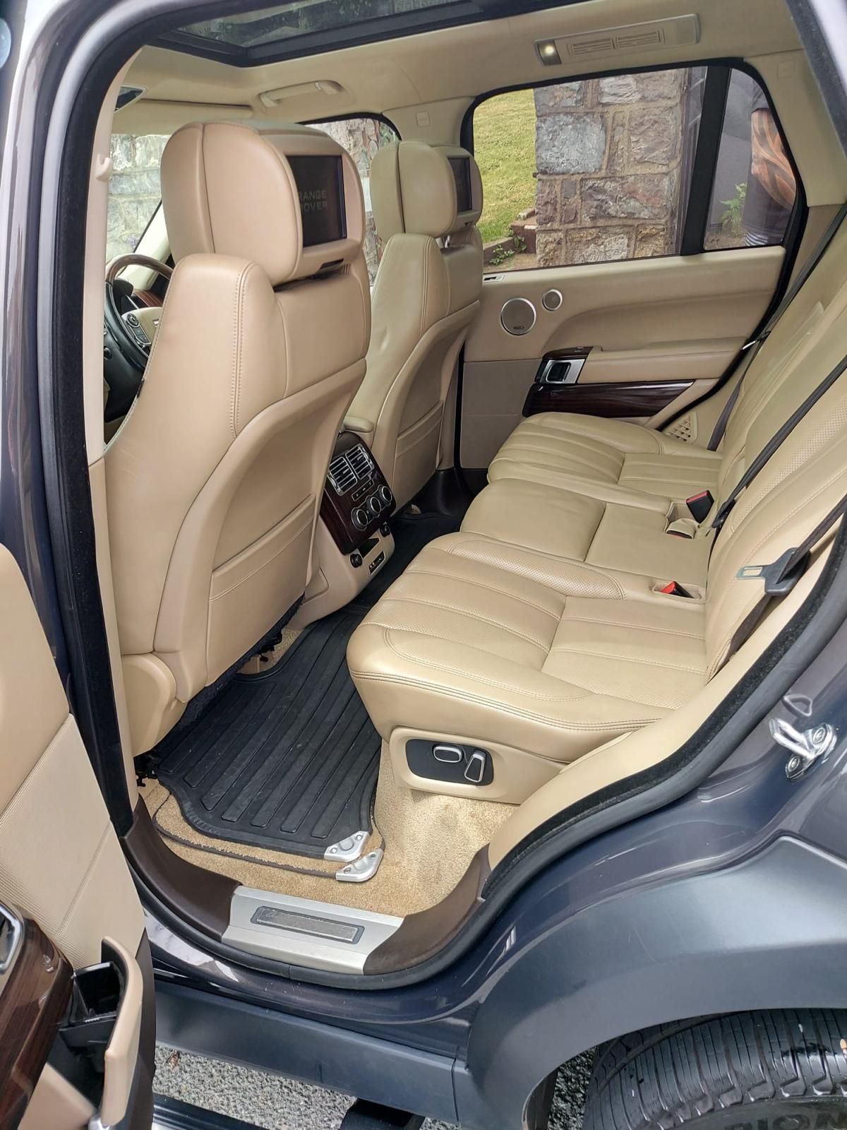 The interior of a range rover sport with white leather seats and a steering wheel has been detailed.
