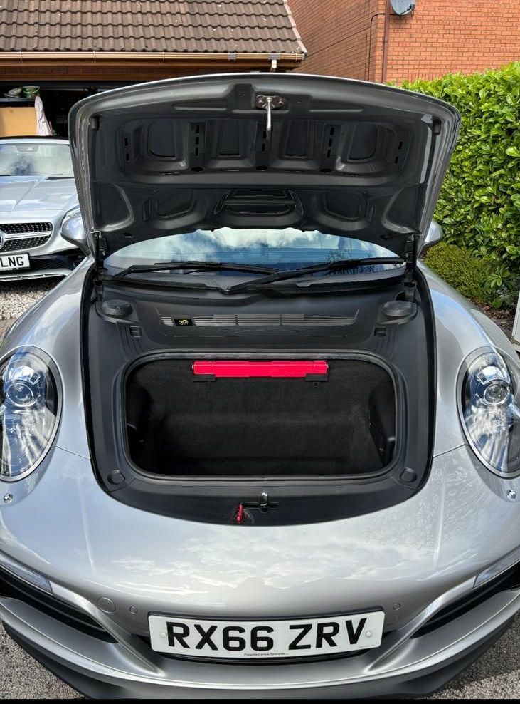 The interior of a range rover sport with white leather seats.
