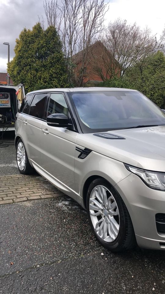 A silver range rover sport has been valeted.