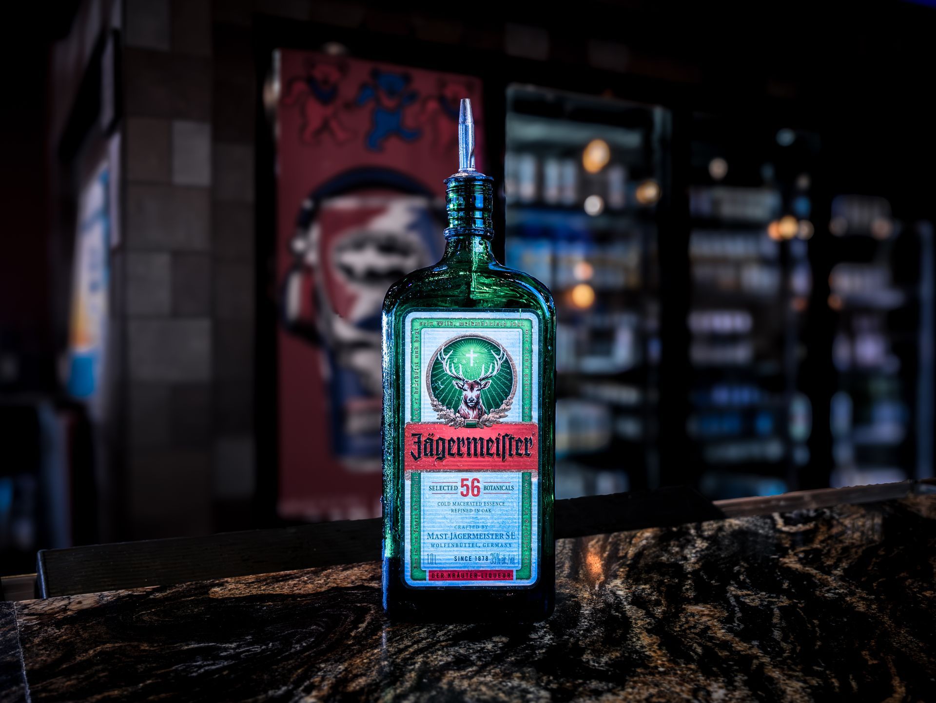A bottle of jagermeister is sitting on a bar counter.