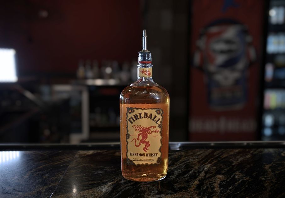 A bottle of fireball whiskey sits on a bar