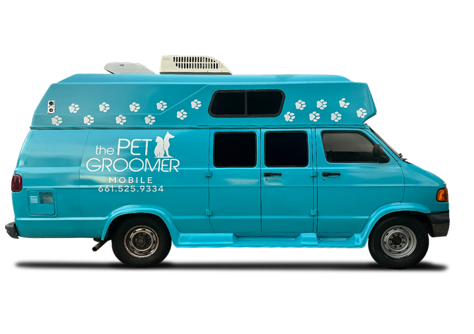 A blue van that says the pet groomer on it