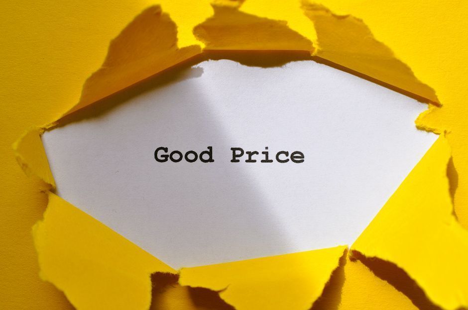White paper with “Good Price” revealed through torn yellow paper