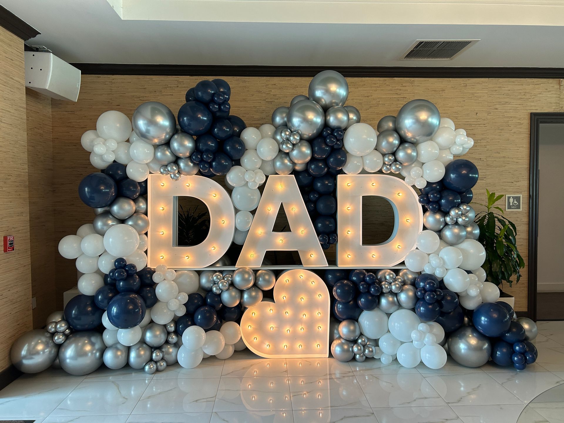 A pink hospital decorated with balloons and flowers for a birthday party.