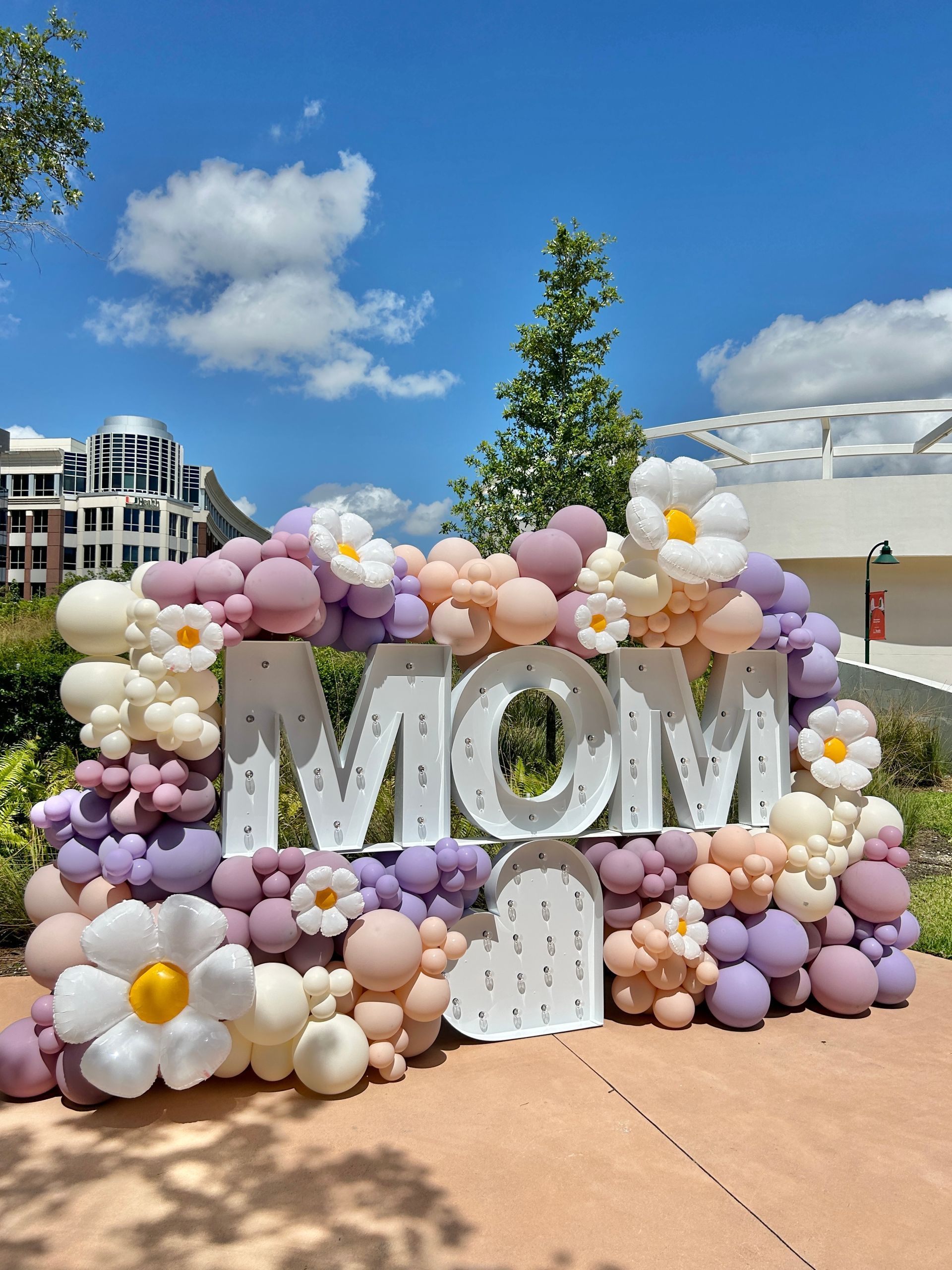 A pink hospital decorated with balloons and flowers for a birthday party.