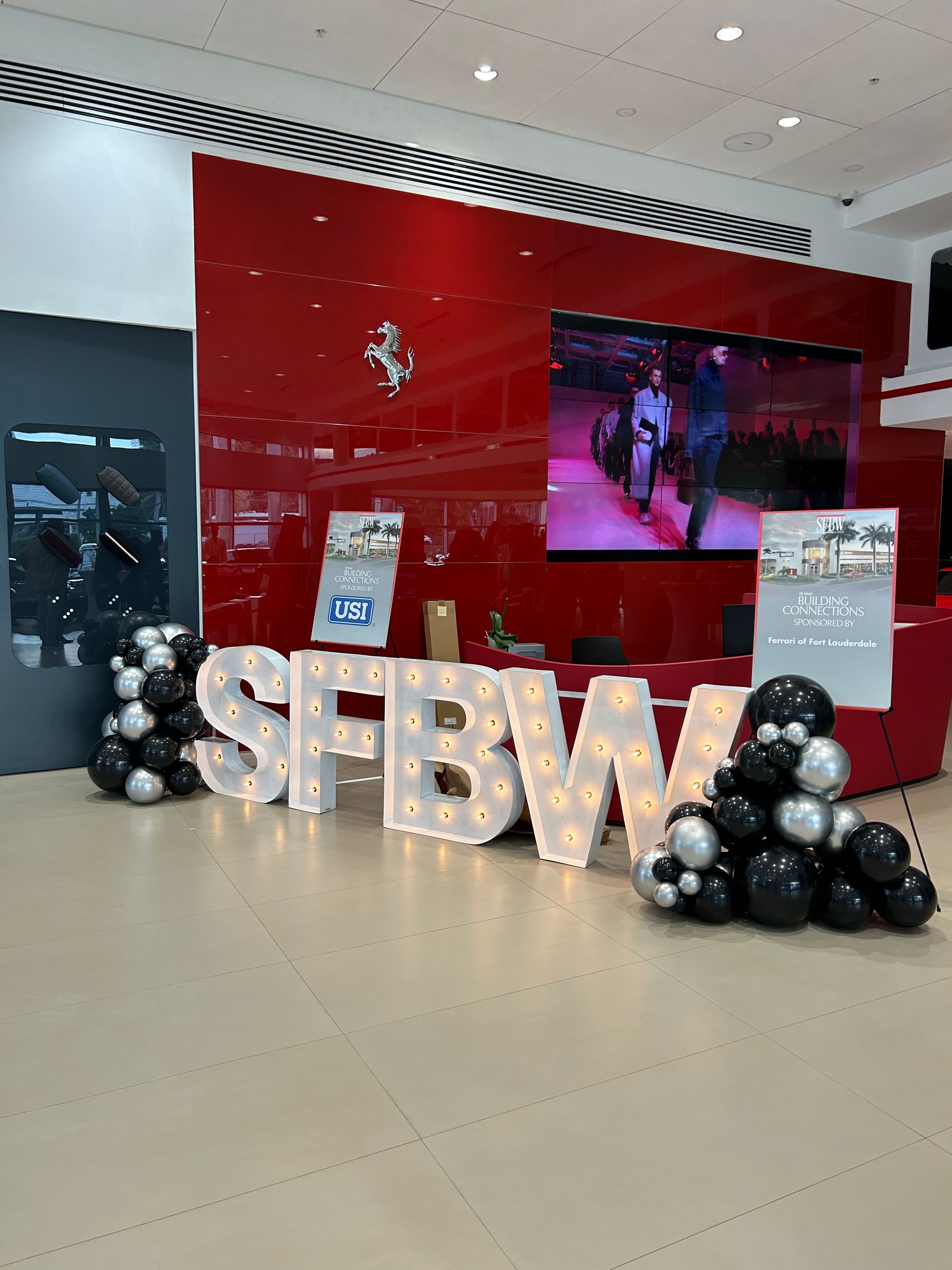 Light up marquee letters with balloons around it