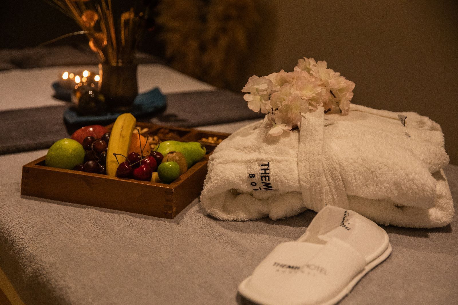 There is a tray of fruit and a towel on the table.