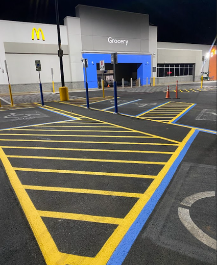 A large house with a blue roof and a blue door is lit up at night.