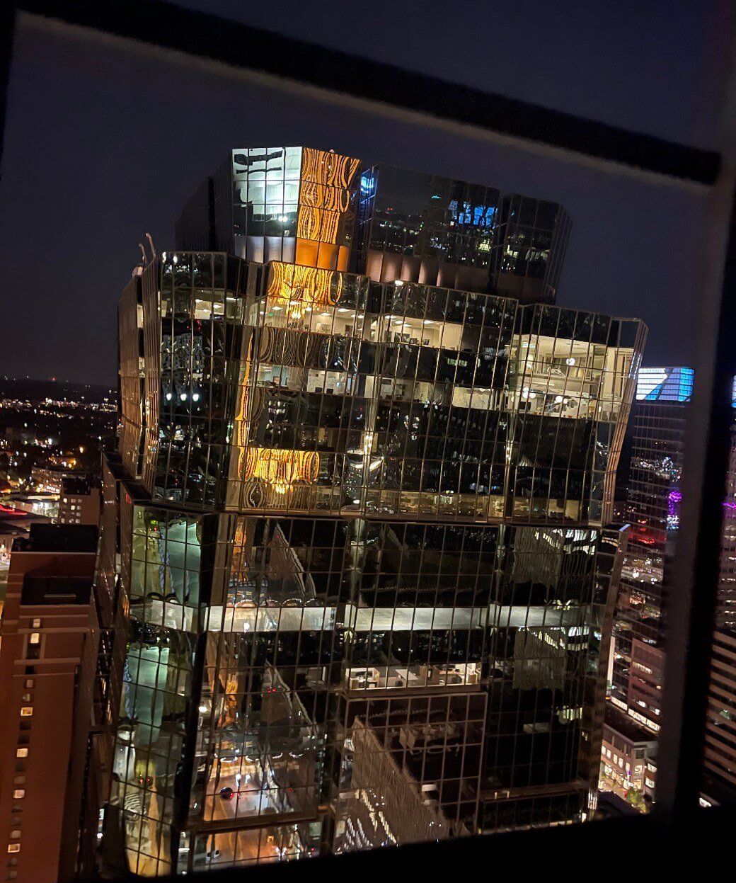 Reflective skyscraper downtown Minneapolis at night.