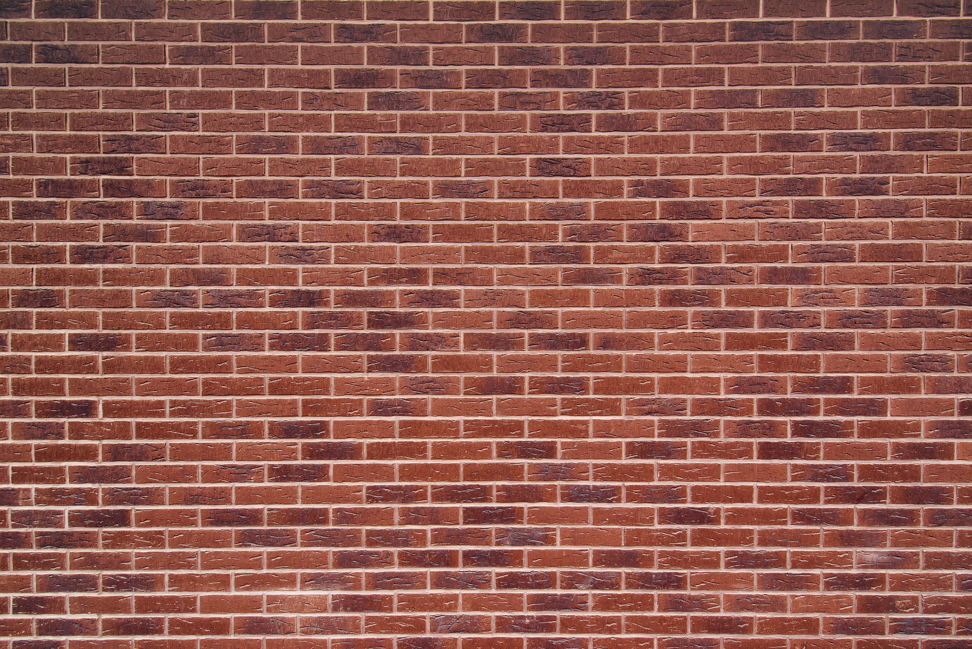 Red brick wall with aged, weathered texture.