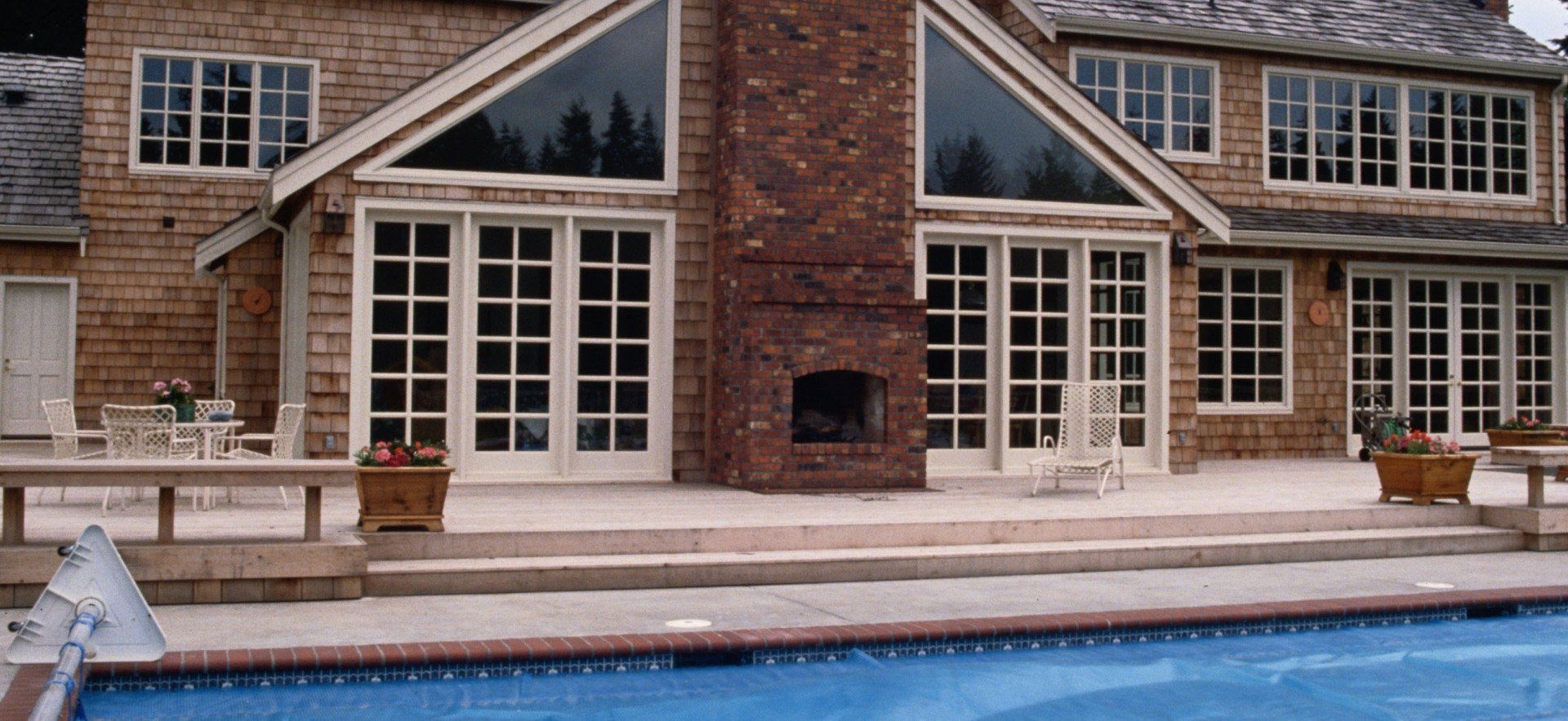 Fireplace with stone surround, black firebox, and exposed wires on a gray wall.