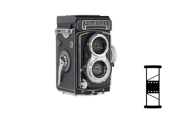 Black and silver Rolleiflex twin-lens camera with a film spool outline.