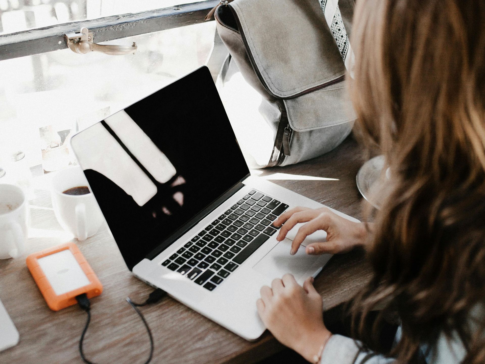 a sony camera is surrounded by lenses and a tripod