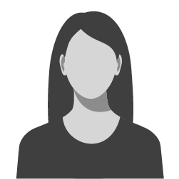 Grayscale portrait of a woman with long, dark hair, and a simple dark shirt, facing forward.