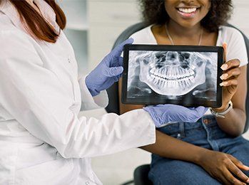 Tablet with Patient X-ray Panoramic Jaw — Palmdale, CA — Posada Dental Practice