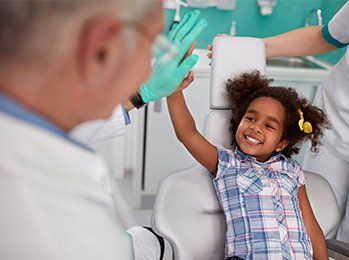 Lovely Kid in Dental Chair with Dentist — Palmdale, CA — Posada Dental Practice