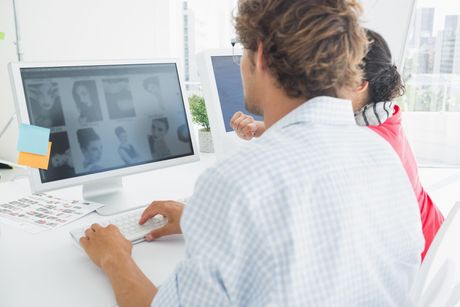 a man sitting at a desk using a computer