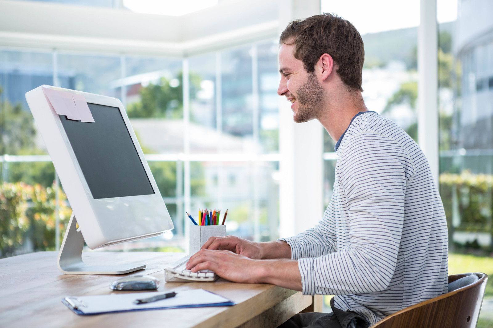 a man sitting at a desk using a computer