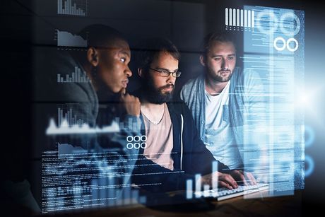 a group of men looking at a computer screen